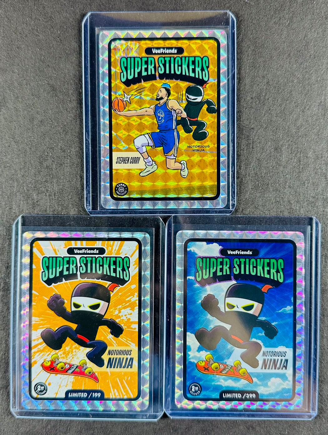 VeeFriends Super Stickers – Notorious Ninja 3-Card Bundle – Orange Splash /199 + Manga Clouds /399 + Curry Crossover