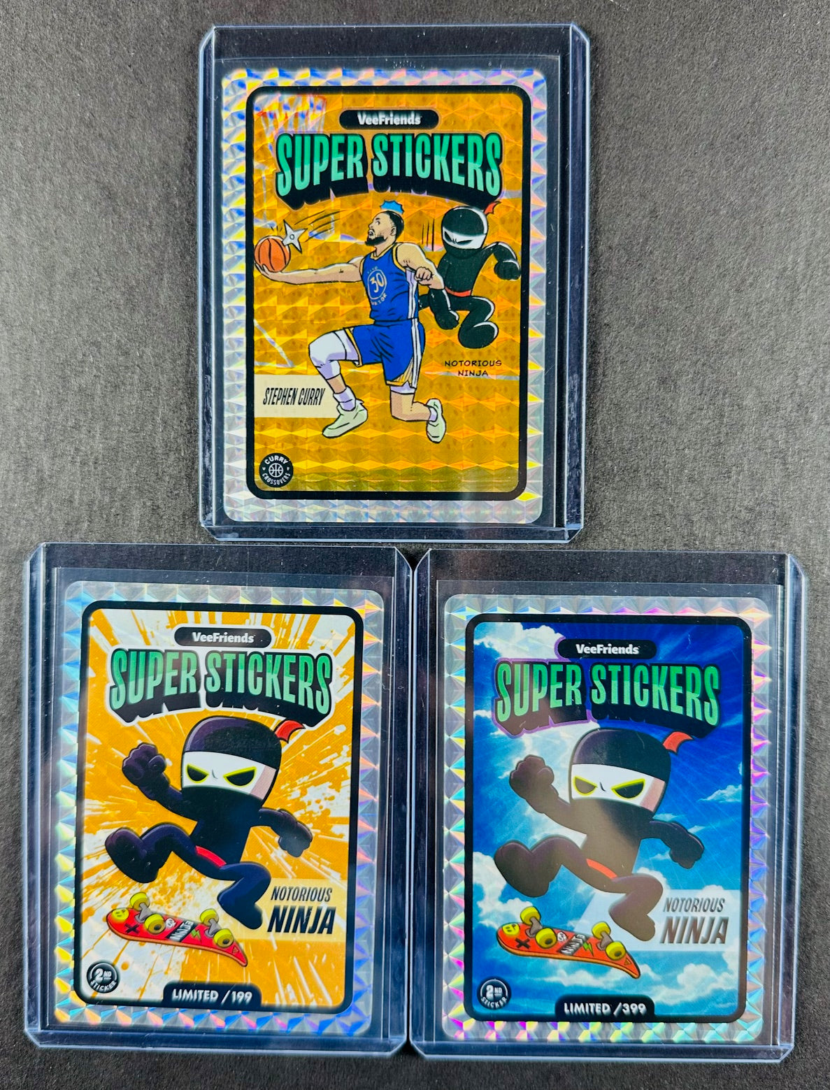 VeeFriends Super Stickers – Notorious Ninja 3-Card Bundle – Orange Splash /199 + Manga Clouds /399 + Curry Crossover