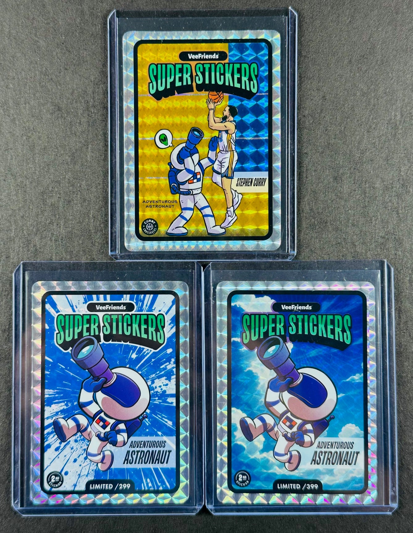 VeeFriends Super Stickers – Adventurous Astronaut 3-Card Bundle – Blue Splash /299 + Manga Clouds /399 + Curry Crossover