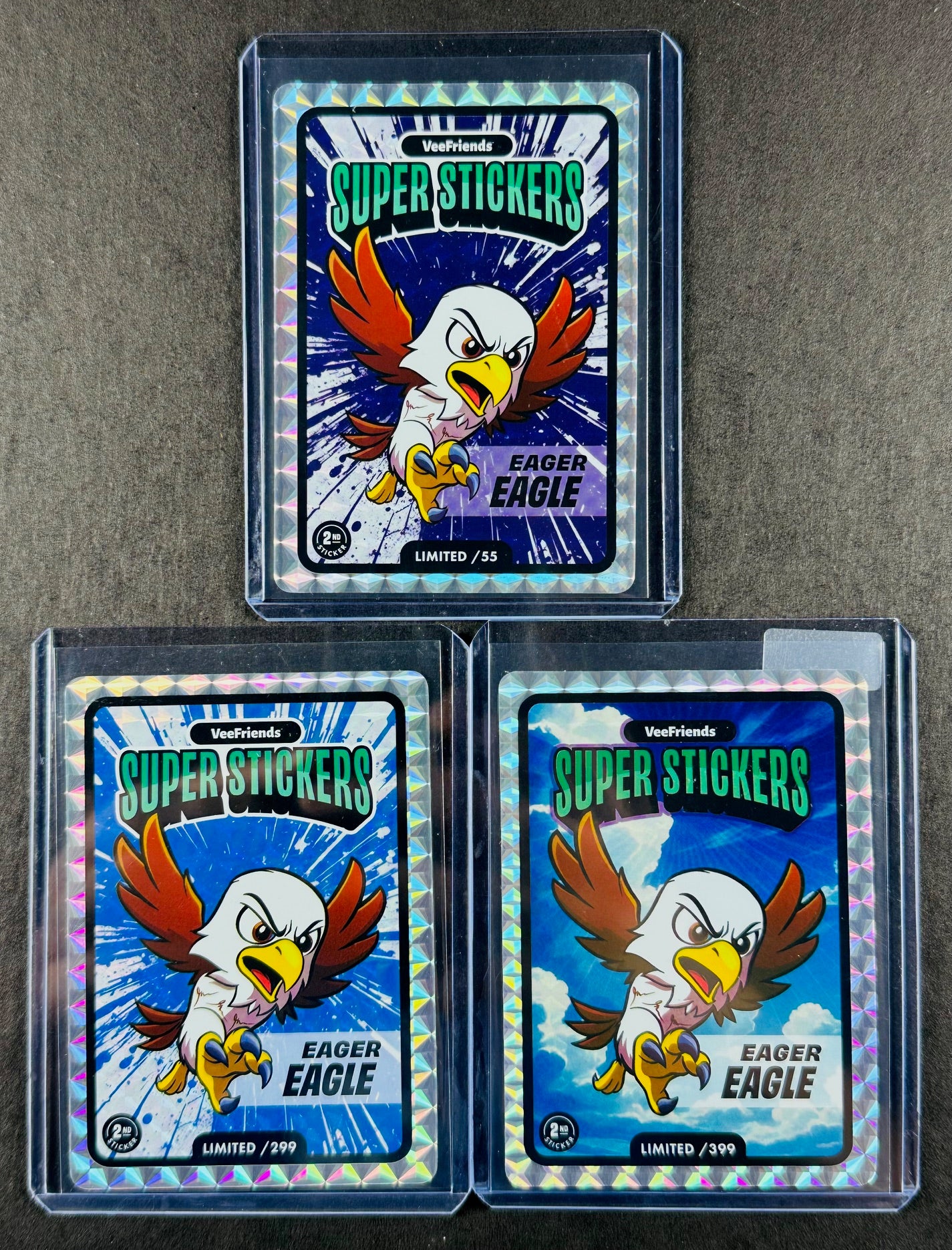 VeeFriends Super Stickers – Eager Eagle 3-Card Bundle – Purple Splash /55 + Blue Splash /299 + Manga Clouds /399