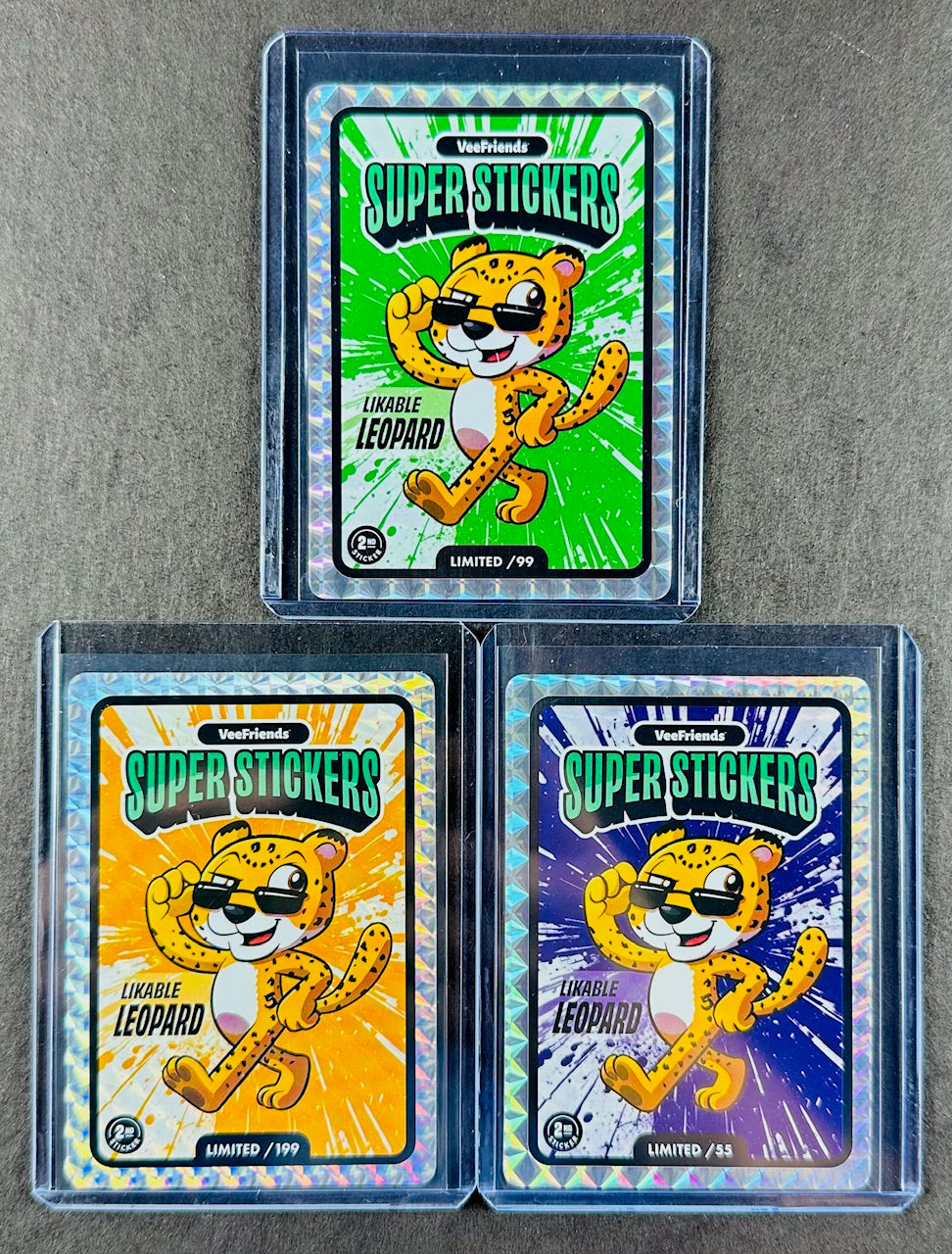 VeeFriends Super Stickers – Likable Leopard 3-Card Bundle – Green Splash /99 + Orange Splash /199 + Purple Splash /55
