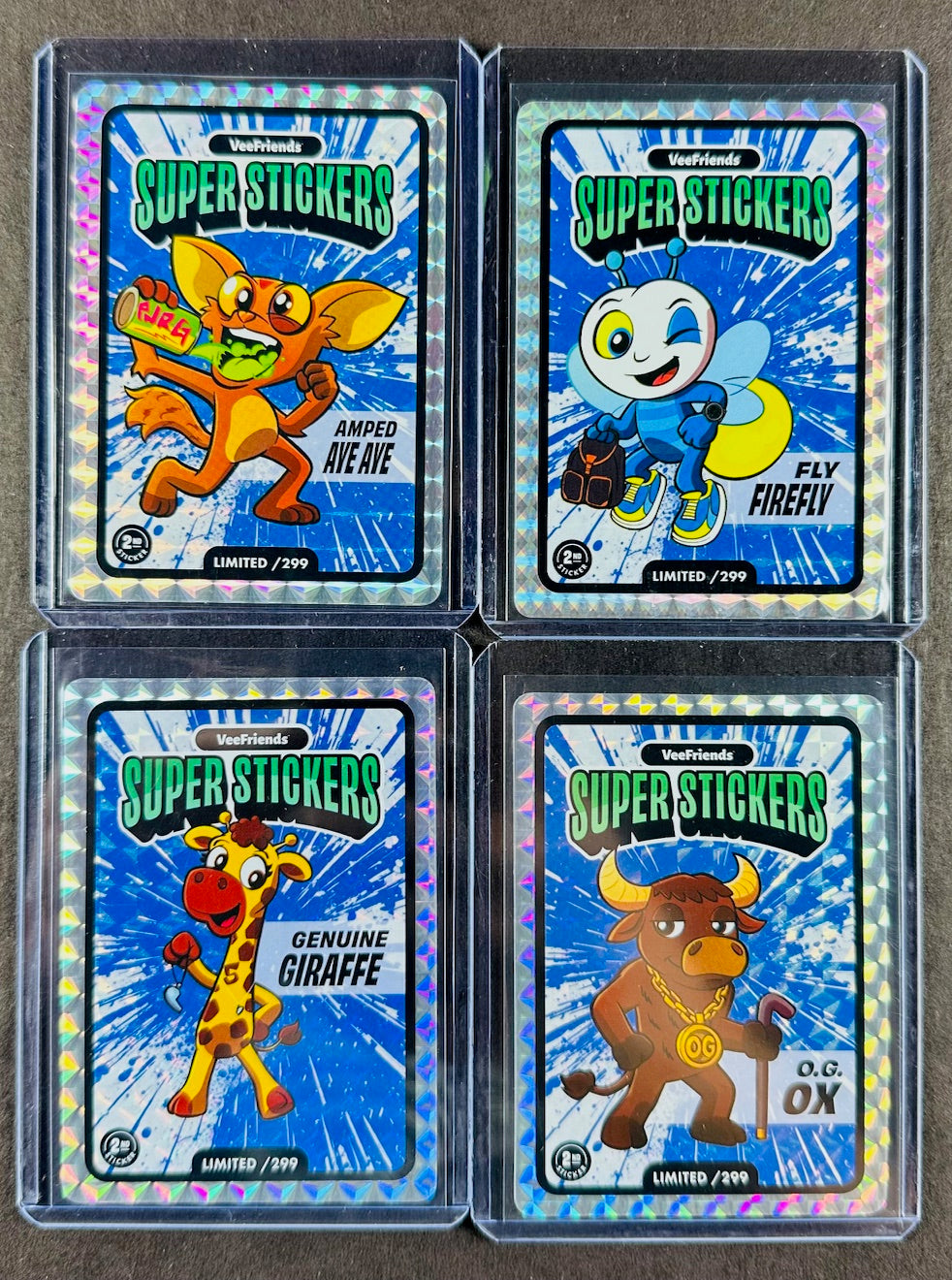 VeeFriends Super Stickers – 4-Card Blue Splash Bundle – Amped Aye Aye /299 + Fly Firefly /299 + Genuine Giraffe /299 + O.G. Ox /299